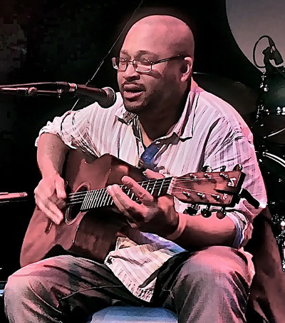 Damon on stage with guitar